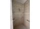 Tiled shower with shower head and grab bar at 3402 Amberjack Dr, Hernando Beach, FL 34607
