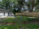 A fenced backyard with a large lawn, a concrete patio, and newly installed wood privacy fence at 34819 Hibiscus Dr, Dade City, FL 33523