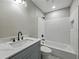 Nicely updated bathroom with white subway tile, gray vanity with marble countertop, and modern fixtures at 34819 Hibiscus Dr, Dade City, FL 33523