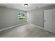 Bedroom featuring new paint, woodgrain floors, and a window overlooking the street at 34819 Hibiscus Dr, Dade City, FL 33523