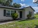 Exterior shot showcasing painted brick, contrasting shutters, and manicured landscaping at 34819 Hibiscus Dr, Dade City, FL 33523