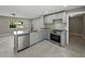 Kitchen view with granite countertops, stainless steel appliances, and soft-close cabinets at 34819 Hibiscus Dr, Dade City, FL 33523