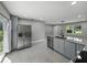 Kitchen features stainless steel appliances, granite countertops, and gray shaker cabinets at 34819 Hibiscus Dr, Dade City, FL 33523