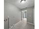 A spacious laundry area featuring modern lighting, neutral tones, and wood-look tile flooring at 34819 Hibiscus Dr, Dade City, FL 33523