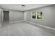 Bright living room featuring fresh paint, woodgrain floors and a large window overlooking the front yard at 34819 Hibiscus Dr, Dade City, FL 33523