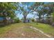 Expansive backyard featuring a large tree providing shade and privacy with a traditional wooden fence surround at 3544 6Th S Ave, St Petersburg, FL 33711