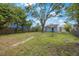 Open backyard showing mature trees and a wooden fence, offering a private and spacious outdoor area at 3544 6Th S Ave, St Petersburg, FL 33711