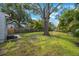 Large backyard with mature tree and partial fence at 3544 6Th S Ave, St Petersburg, FL 33711