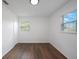 Cozy bedroom with natural light from two windows and wood-look floors at 3544 6Th S Ave, St Petersburg, FL 33711