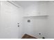 Laundry room with storage cabinets and white painted door at 3544 6Th S Ave, St Petersburg, FL 33711