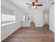 An open living room with hardwood floors and view of the kitchen at 3544 6Th S Ave, St Petersburg, FL 33711