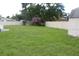 Spacious backyard with a white fence and storage shed at 38668 Ferm Cir, Zephyrhills, FL 33540