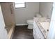 Bright bathroom featuring a walk-in shower and a granite countertop vanity with white cabinets at 38668 Ferm Cir, Zephyrhills, FL 33540