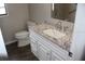 Bathroom with a white vanity and granite countertop, toilet and tiled shower at 38668 Ferm Cir, Zephyrhills, FL 33540