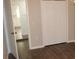 Bedroom with hardwood floors and open doorway to the kitchen at 38668 Ferm Cir, Zephyrhills, FL 33540