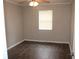 Cozy bedroom featuring hardwood floors, a ceiling fan, and a bright window at 38668 Ferm Cir, Zephyrhills, FL 33540