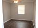 Cozy bedroom featuring hardwood floors, a ceiling fan, and a bright window at 38668 Ferm Cir, Zephyrhills, FL 33540