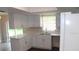 Bright kitchen with white cabinets and countertops, and stainless steel appliances at 38668 Ferm Cir, Zephyrhills, FL 33540