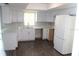 Bright kitchen with white cabinets, modern countertops, and stainless steel appliances at 38668 Ferm Cir, Zephyrhills, FL 33540
