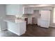 Modern kitchen with white cabinets, stylish countertops, and stainless steel refrigerator at 38668 Ferm Cir, Zephyrhills, FL 33540