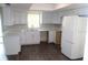 Bright kitchen with white cabinets, modern countertops, and stainless steel appliances at 38668 Ferm Cir, Zephyrhills, FL 33540