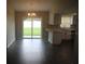 Open-concept living room with sliding glass doors to the backyard and eat in kitchen at 38668 Ferm Cir, Zephyrhills, FL 33540