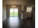 Open-concept living room with sliding glass doors to the backyard and eat in kitchen at 38668 Ferm Cir, Zephyrhills, FL 33540