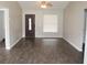 Open concept living room with hardwood floors and lots of natural light at 38668 Ferm Cir, Zephyrhills, FL 33540