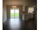 Open-concept living room with sliding glass doors to the backyard and eat in kitchen at 38668 Ferm Cir, Zephyrhills, FL 33540
