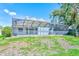Rear view of the screened in pool and patio area with a sloping lawn at 4008 Moreland Dr, Valrico, FL 33596