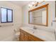 A bathroom featuring a wood-framed mirror and vanity with ceramic tile flooring at 4008 Moreland Dr, Valrico, FL 33596