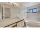 Clean bathroom with a large vanity, a built-in bathtub, and essential fixtures for comfort and convenience at 4008 Moreland Dr, Valrico, FL 33596