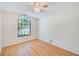 A well-lit bedroom features hard surface floors, a ceiling fan, and a window at 4008 Moreland Dr, Valrico, FL 33596