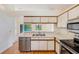 Functional kitchen with stainless steel appliances and convenient access to the living area and outdoor pool view at 4008 Moreland Dr, Valrico, FL 33596
