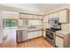 Efficient kitchen with stainless steel appliances, white cabinets, and a view of the pool at 4008 Moreland Dr, Valrico, FL 33596