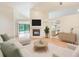 Bright living room with hardwood floors, a cozy fireplace, and seamless access to the outdoor pool area at 4008 Moreland Dr, Valrico, FL 33596