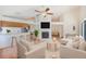 Open-concept living area with modern decor, a fireplace, and seamless connection to the kitchen and dining space at 4008 Moreland Dr, Valrico, FL 33596