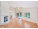 Spacious living room with fireplace, fan, and sliding glass doors that lead to the pool area at 4008 Moreland Dr, Valrico, FL 33596