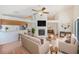 Living room featuring a fireplace, ceiling fan, bar seating area, and a comfortable seating area at 4008 Moreland Dr, Valrico, FL 33596