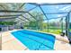 Screened-in pool with a clear view of a tranquil lake, providing a perfect spot for relaxation and recreation at 4008 Moreland Dr, Valrico, FL 33596