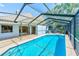 Wide shot of the screened-in pool and outdoor patio area with lake views at 4008 Moreland Dr, Valrico, FL 33596