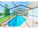 Inviting screened-in pool area with beautiful lake views and lush landscaping at 4008 Moreland Dr, Valrico, FL 33596