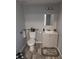 Powder room with gray walls, a toilet, and a sink with a gray cabinet at 4802 Drift Tide Dr, New Port Richey, FL 34652