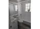 Clean bathroom with white tile, gray flooring, and a shower-tub combo at 4802 Drift Tide Dr, New Port Richey, FL 34652