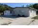 Charming single-story home with a well-maintained exterior, spacious driveway, and a light gray facade at 4802 Drift Tide Dr, New Port Richey, FL 34652