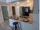Modern kitchen showcasing granite counters, stainless appliances, and adjacent rooms through doorways at 4802 Drift Tide Dr, New Port Richey, FL 34652