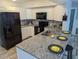 Modern kitchen with stainless steel appliances, granite counters, and stylish backsplash at 4802 Drift Tide Dr, New Port Richey, FL 34652