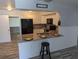 Contemporary kitchen featuring stainless steel appliances, granite counters, and seating at the island at 4802 Drift Tide Dr, New Port Richey, FL 34652