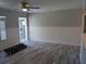 A bright living room featuring wood-look floors, neutral paint, and bead board trim at 4802 Drift Tide Dr, New Port Richey, FL 34652