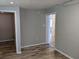 Neutral living space with plank flooring and doorways leading to other rooms in the home at 4802 Drift Tide Dr, New Port Richey, FL 34652
